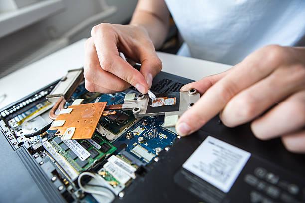 man repairing a computer. Man changes the thermal grease in the computer's cooling system. laptop clean thermal